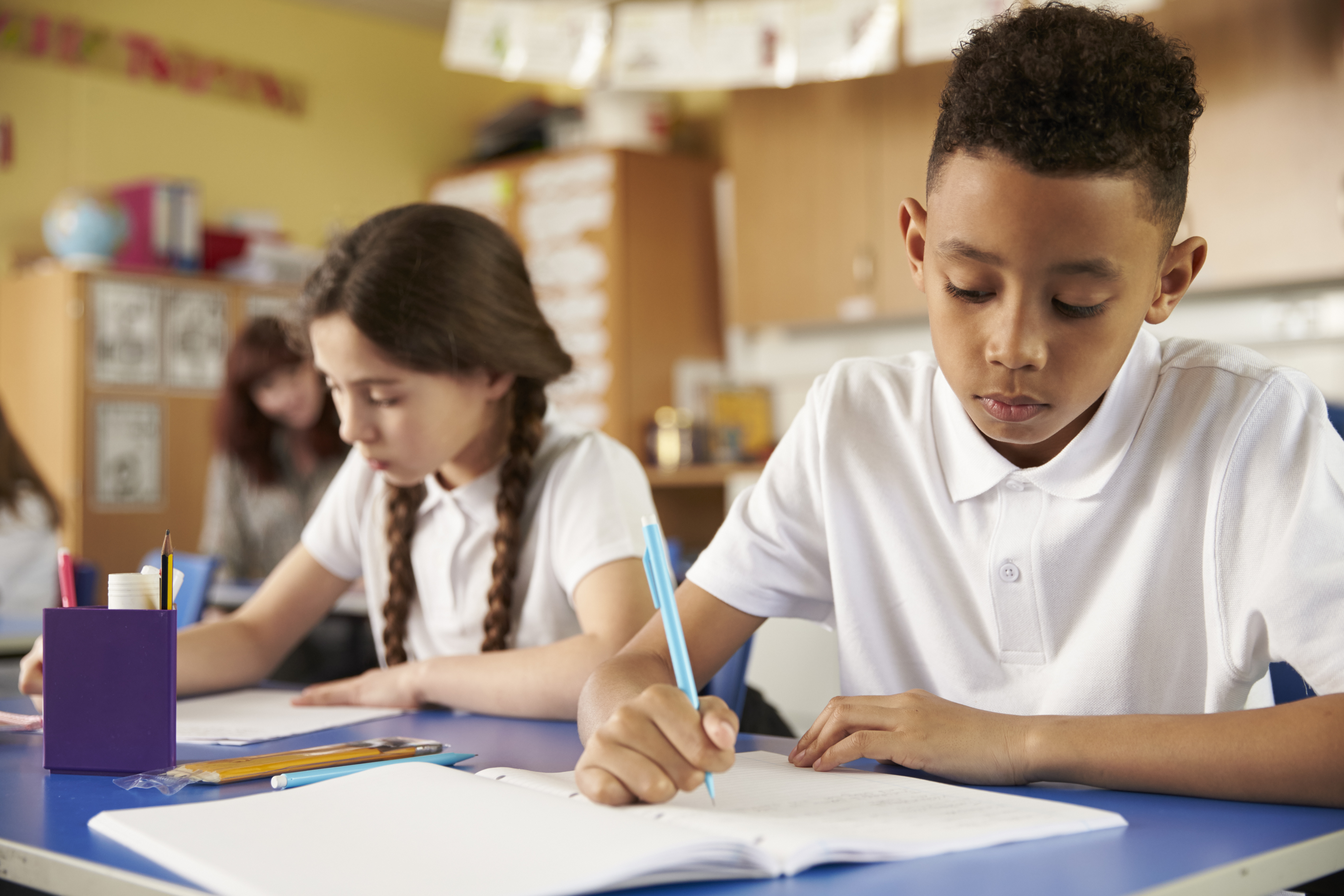 primary boy and girl writing