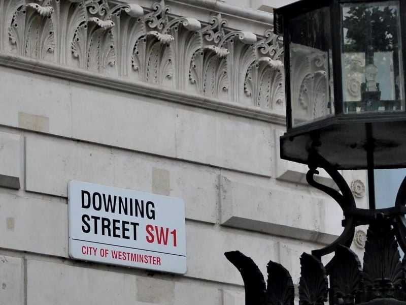 A building with a street sign that reads 'Downing Street SW1'